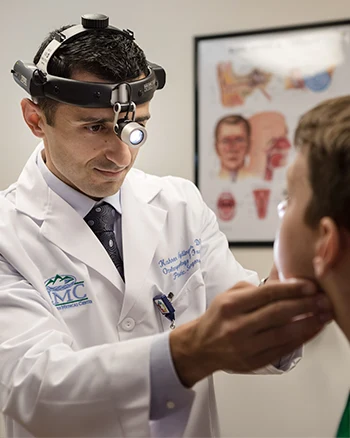 Ear nose and throat doctor examining a patient in the office