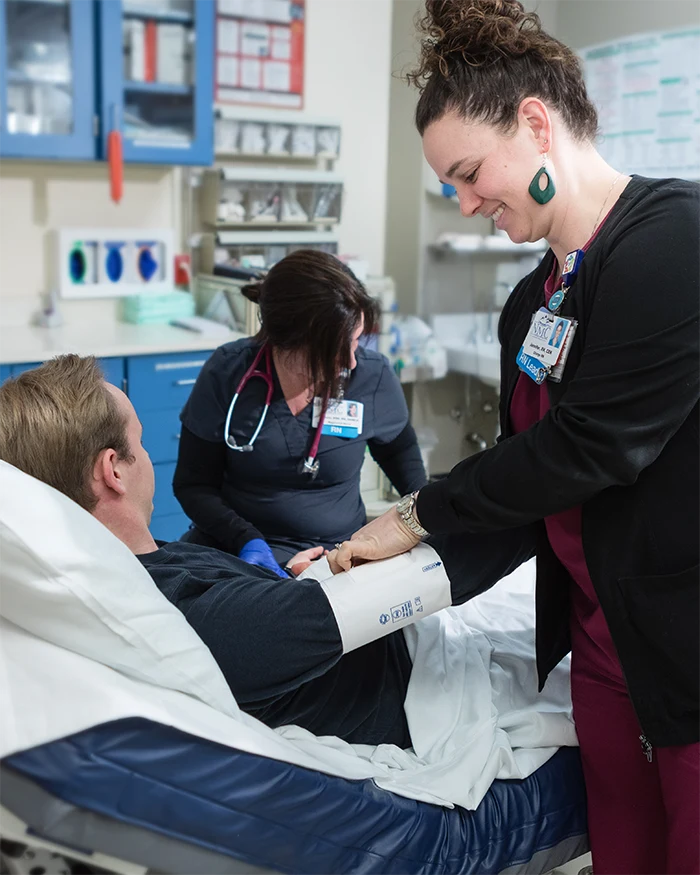 Two ER nurses examining a patient