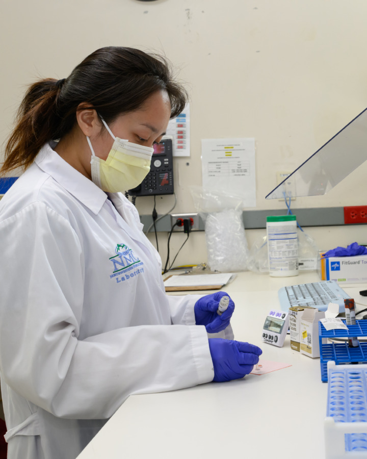 NMC Lab staff member working with sample